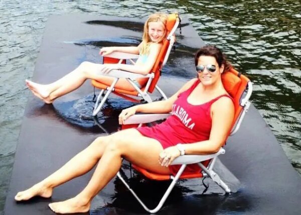 Two women in chairs on top of a floating water mat